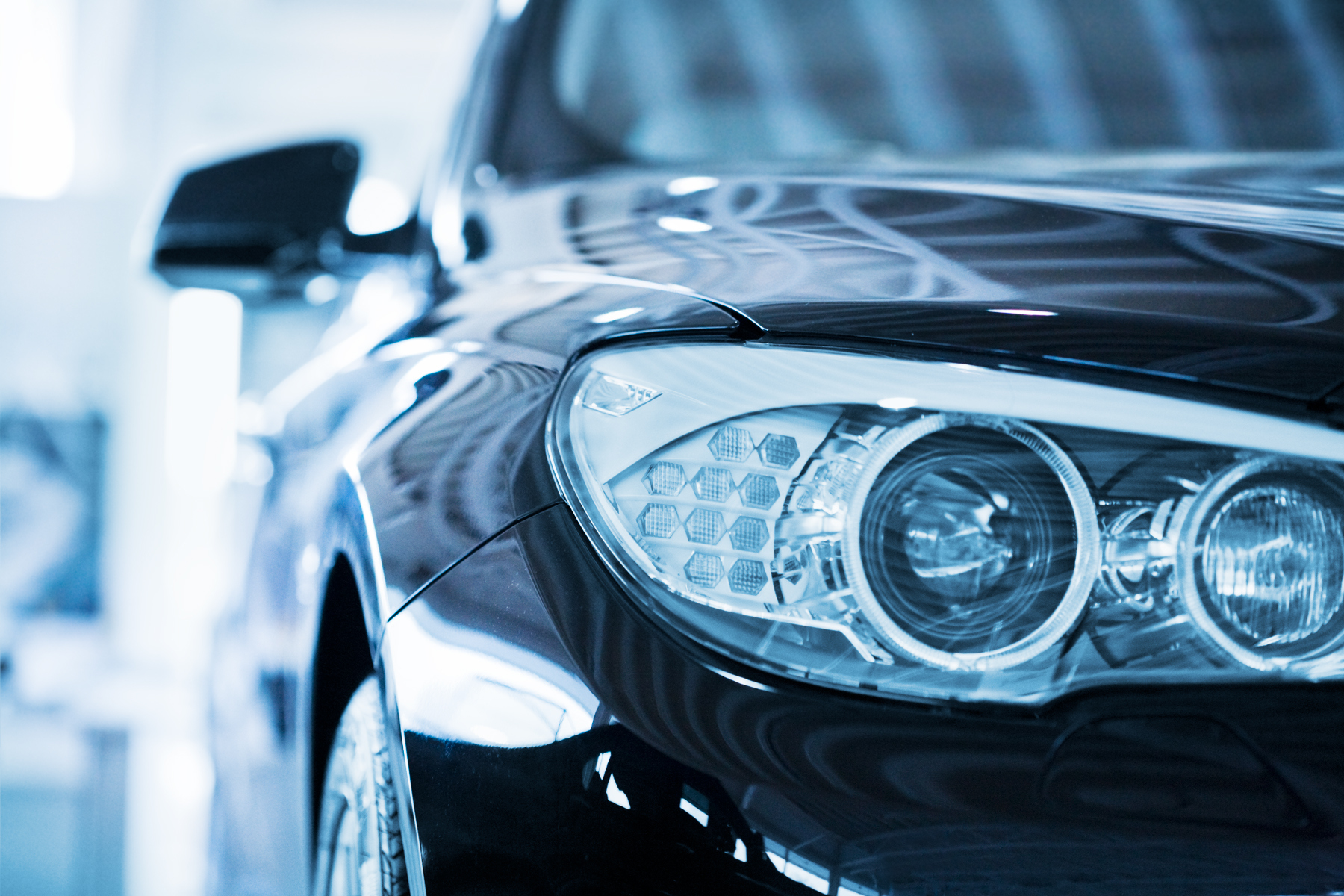 Hamburg, Germany - May 2,  2010 : Close up from the left front of a parking blue BMW 530d. Shallow depth of field with fokus on the headlight. BMW is a German automobile, motorcycle and engine manufacturing company founded in 1916